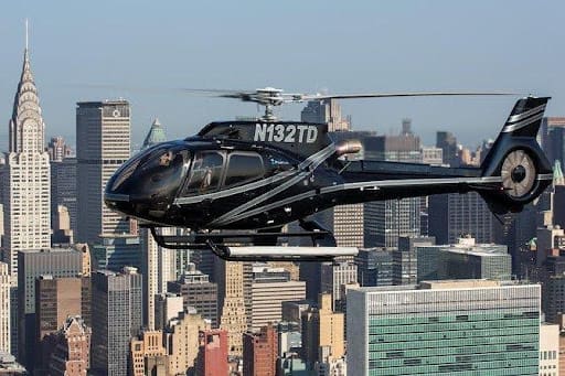 A helicopter flying over the city of new york.